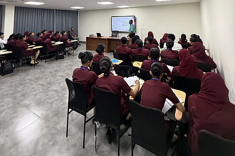 Students in uniform attending a lecture