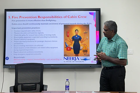 A trainer presenting fire prevention responsibilities of cabin crew to a class