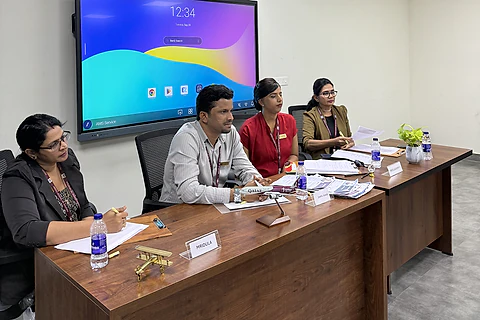 A four-member panel seated at a table during an interview practice session