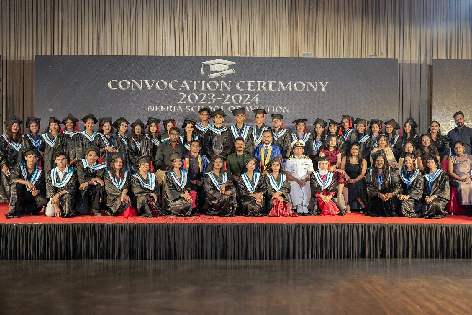 Neerja School of Aviation graduates and staff on stage at the 2023–2024 convocation ceremony