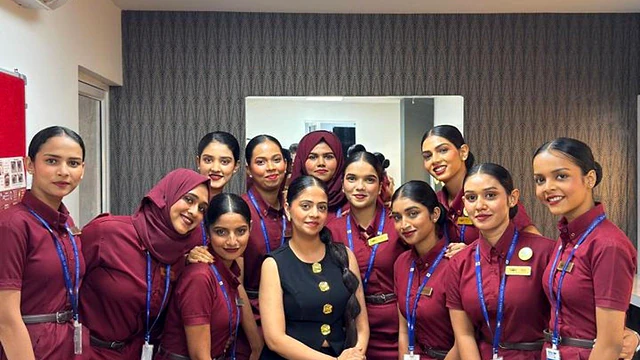 A group of students in uniform with a member of staff